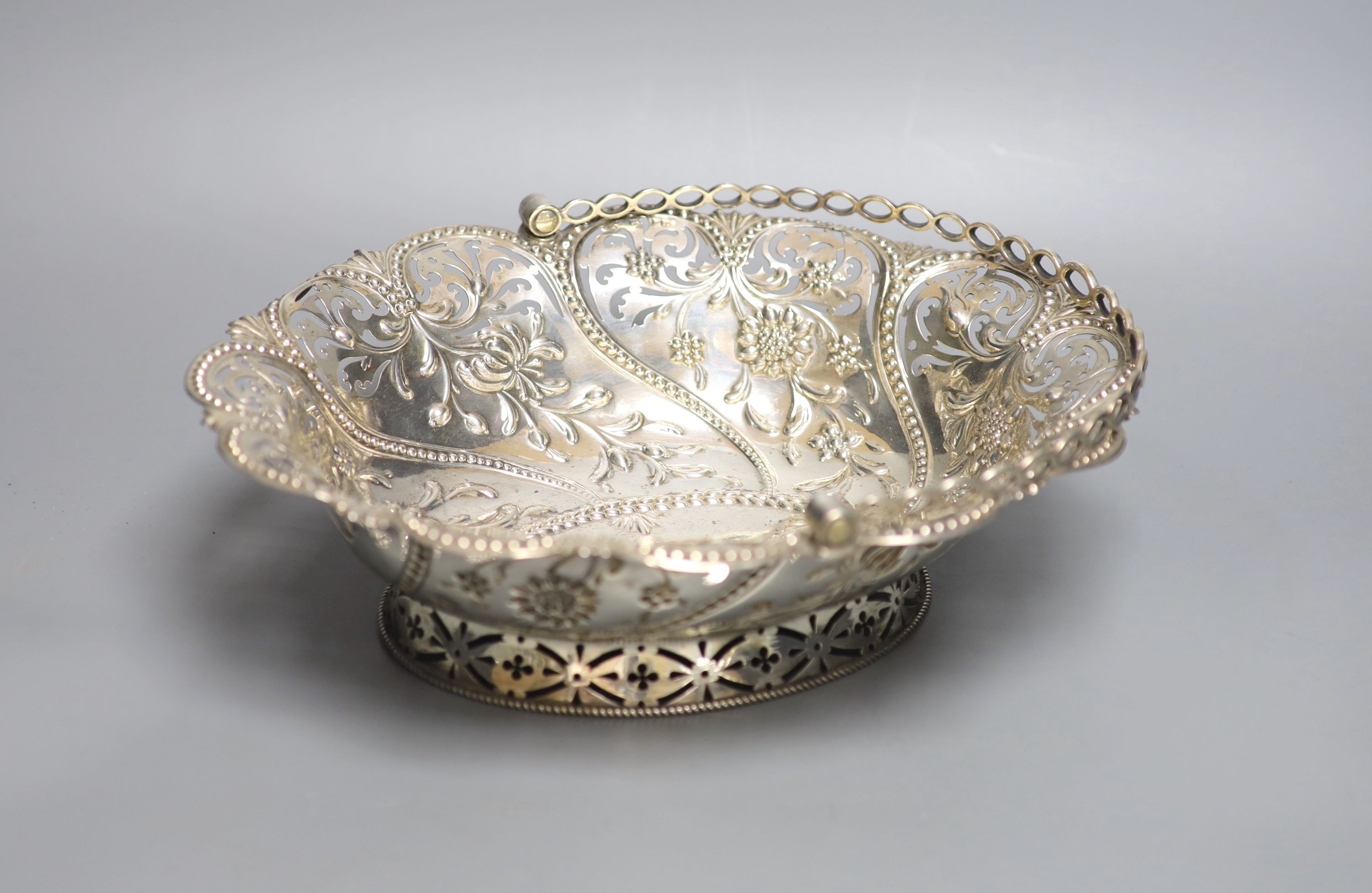 An early George III silver basket, with later? pierced and embossed decoration, Richard Meach, London, 1768, length 30.8cm, 21oz.